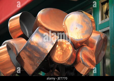 Copper pots hanging from the ceiling in the kitchen Stock Photo