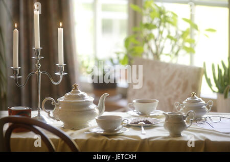 Coffee table, covered, porcelain, elegantly, table, table caps, white, dishes, china, tea service, cups, teapot, tea drinking, Teatime, tea, sugar bowl, lacteal pot, biscuits, reading glasses, candlesticks, skyers, candle-light, chair, window, nobody, Stock Photo