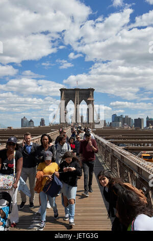 people walking over the brooklyn bridge New York City USA Stock Photo