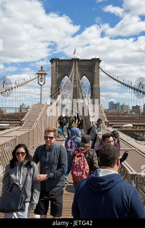 people walking over the brooklyn bridge New York City USA