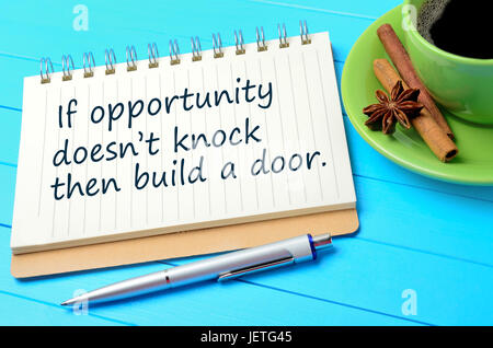 If opportunity doesn't knock then build a door written on notepad closeup Stock Photo