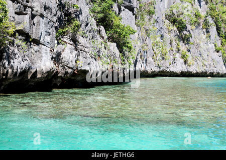 blur in philippines view from a boat of  palm cliff beach and rock from pacific ocean Stock Photo