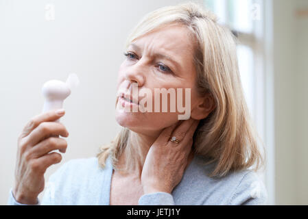 Mature Woman Experiencing Hot Flush From Menopause Stock Photo