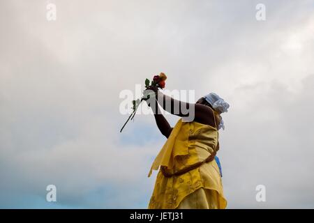 A Baiana woman throws flowers in the sea during the celebration of Yemanya, the goddess of the sea, in Salvador, Bahia, Brazil, 2 February 2012. Yemanya, originally from the ancient Yoruba mythology, is one of the most popular ‚Orixas, the deities from t | usage worldwide Stock Photo