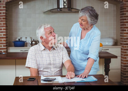 Senior couple discussing with bills Stock Photo