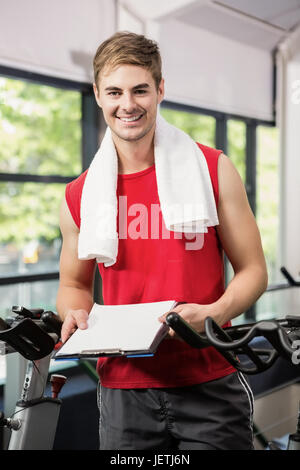 Gym instructor holding clipboard Stock Photo