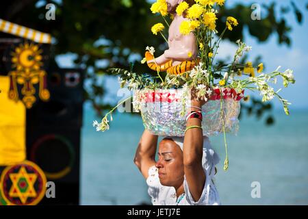 A Baiana woman carries a religious figurine during the ritual procession in honor to Yemanya, the Cadomblegoddess of the sea, in Amoreiras, Bahia, Brazil, 3 February 2012. Yemanya, originally from the ancient Yoruba mythology, is one of the most popular ? | usage worldwide Stock Photo