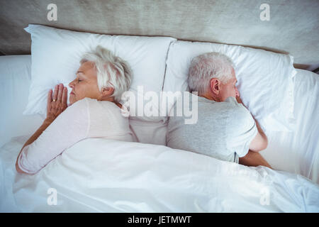 Senior couple sleeping on bed Stock Photo