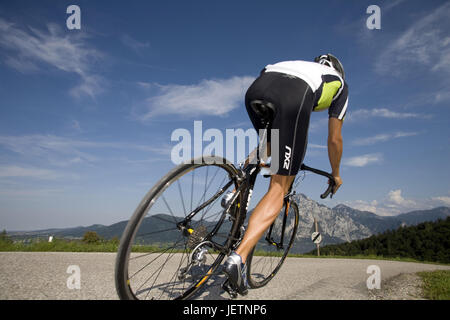 Man with the racing wheel in alpine scenery, Mann mit dem Rennrad in alpiner Landschaft Stock Photo