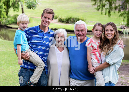 Multi-generation family standing in the park Stock Photo