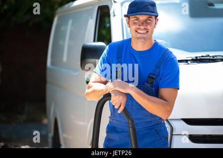 Happy janitor cleaning the car Stock Photo