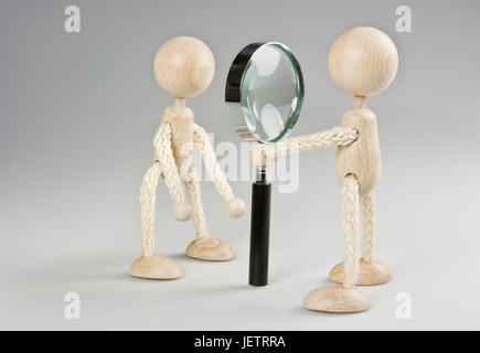 Two wooden figures with magnifying glass, Zwei Holzfiguren mit Lupe Stock Photo