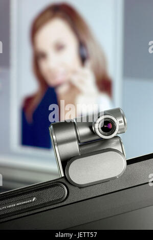 Webcam on monitor, in the background a Screen with portrait of a woman, Webcam auf Monitor, im Hintergrund ein Screen mit Portrait einer Frau Stock Photo