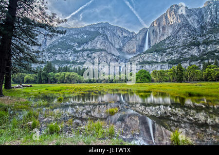 Yosemite Falls and its Reflection on the Water in the Valley Stock Photo