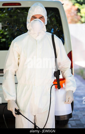 Pest control man standing behind a van Stock Photo