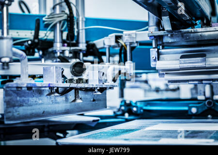 Screen printing machine. Metal industrial machinery. Stock Photo