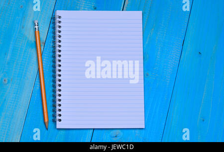 Notepad with pencil on blue wooden table Stock Photo