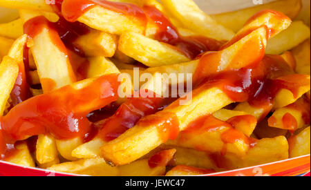 Portion of Take Away Chips with Tomato Sauce Stock Photo