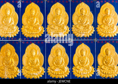 Golden buddha wall tiles located in the Pagoda of Ten Thousand Buddhas at  Kek Lok Si Temple located in Air Itam, Penang, Malaysia. Stock Photo