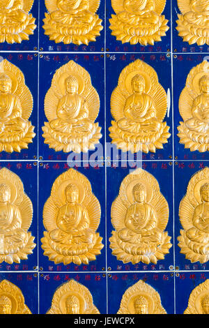 Golden buddha wall tiles located in the Pagoda of Ten Thousand Buddhas at  Kek Lok Si Temple located in Air Itam, Penang, Malaysia. Stock Photo