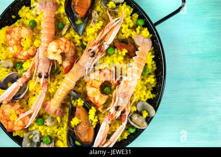 Closeup of Spanish seafood paella in paellera with copyspace Stock Photo