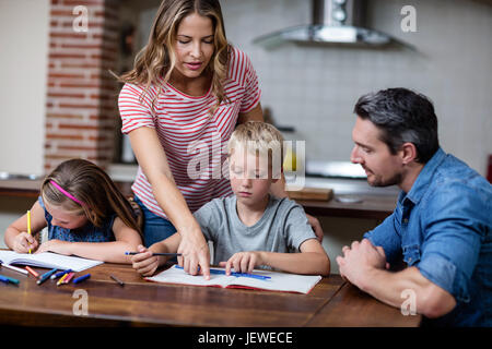 Parents helping the kids with their homework Stock Photo
