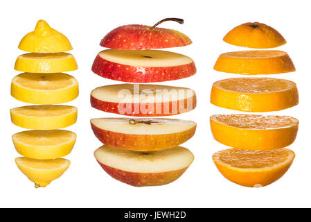 Creative concept with Flying fruits. Sliced orange, lemon, apple isolated on white Stock Photo