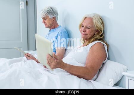 Senior couple using digital tablets Stock Photo