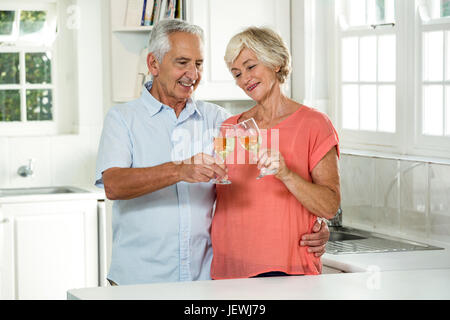 Happy retired couple toasting white wine Stock Photo