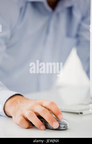 Mid-section of mans hand working on computer Stock Photo