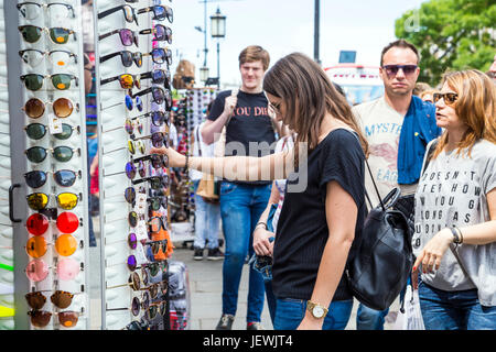 Woman looking at sunglasses in Camden Market, London, UK Stock Photo