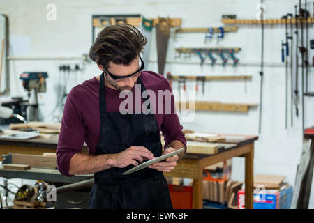 Carpenter is using his tablet Stock Photo