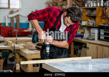 Carpenter using a drill Stock Photo