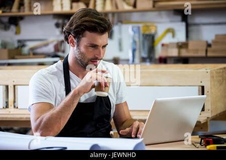 Carpenter is using his tablet Stock Photo