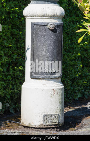 The base of a classic Victorian style street light showing the manufacturer's logo. Made by Revo Tipton. Stock Photo