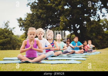 Group on children doing yoga Stock Photo