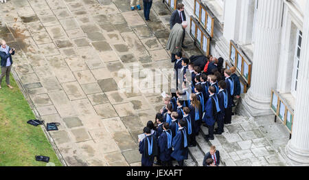 Cambridge, England. 28 June 2017. Dressed in their academic robes, students from Trinity college, University of Cambridge, pose for a photograph outside Senate House after their graduation ceremony on 28 June 2017 Credit: Michael Foley/Alamy Live News Stock Photo