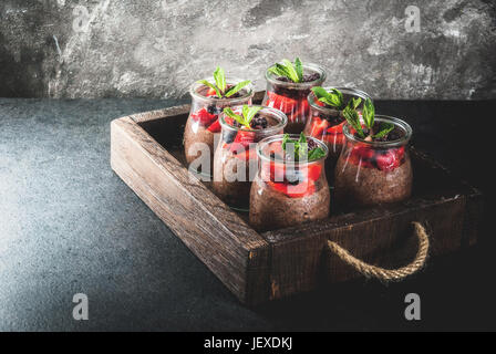Healthy vegan breakfast. Dessert. Alternative food. Pudding with chia seeds, fresh strawberries, blackberries and mint. On a dark stone background, in Stock Photo