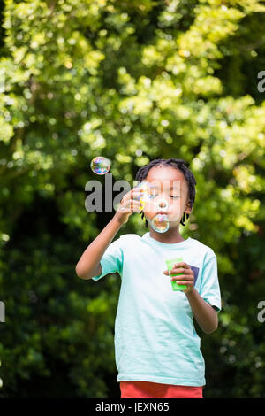Boy is blowing bubbles Stock Photo