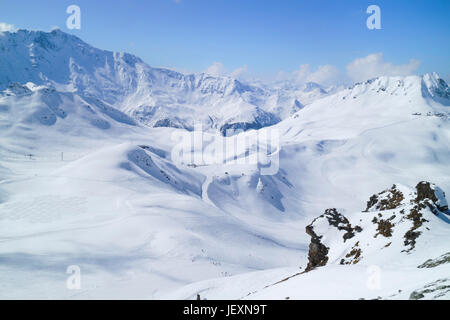 Alpine snowy peaks landscape with skiing slopes and lifts in Paradiski ski area, Alps, France Stock Photo
