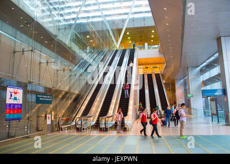 SINGAPORE - JAN 13, 2017 : Escalators at Changi International Airport in Singapore. Changi Airport serves more than 100 airlines operating 6,100 weekl Stock Photo