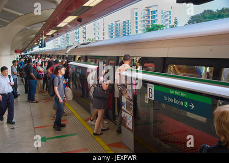 SINGAPORE - JAN 13, 2017: Passengers in Singapore Mass Rapid Transit (MRT) train. The MRT has 102 stations and is the second-oldest metro system in So Stock Photo