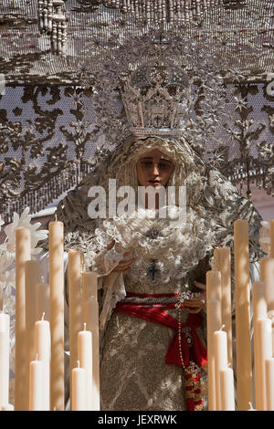 Front with candles, embroidered fabric and flowers of the throne of the Nuestra Se–ora de la Paz, Sevilla, Spain Stock Photo