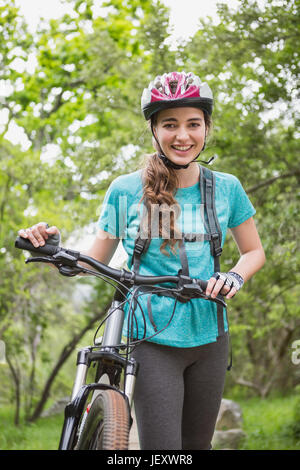 Woman pushing her bike Stock Photo