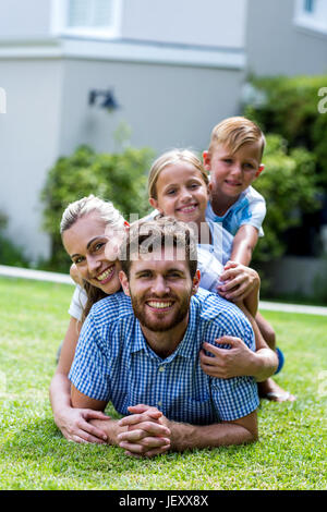 Happy family lying on top of each other Stock Photo