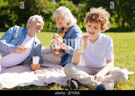Happy grandparents having nice conversation Stock Photo