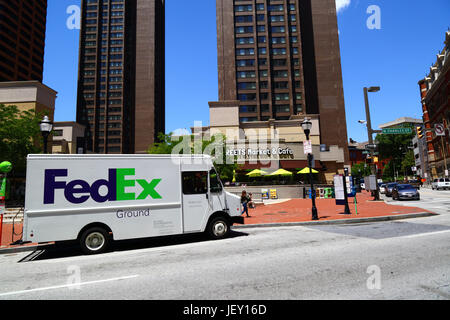 FedEx ground delivery van parked outside Streets Market and Cafe, Charles Towers in background, North Charles Street, Baltimore, Maryland, USA Stock Photo