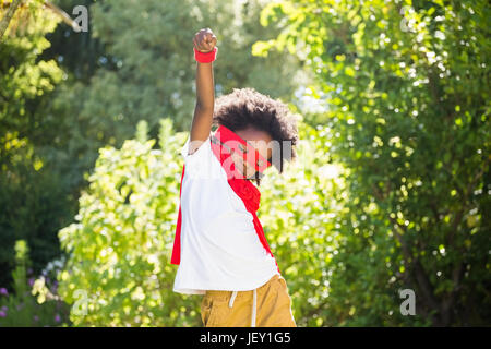 Boy dressed as a super hero in a park Stock Photo