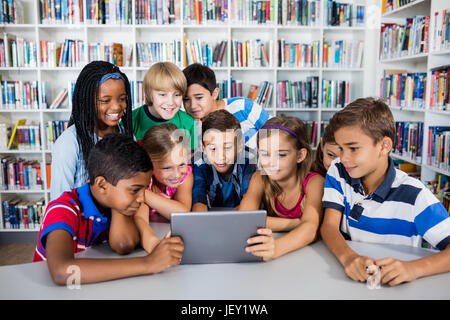 Front view of pupils using tablet pc Stock Photo