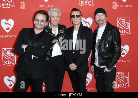 (L-R) Bono, Adam Clayton, Larry Mullen Jr and The Edge or U2 attend the 13th Annual MusiCares Map Fund Benefit Concert in New York, USA Stock Photo